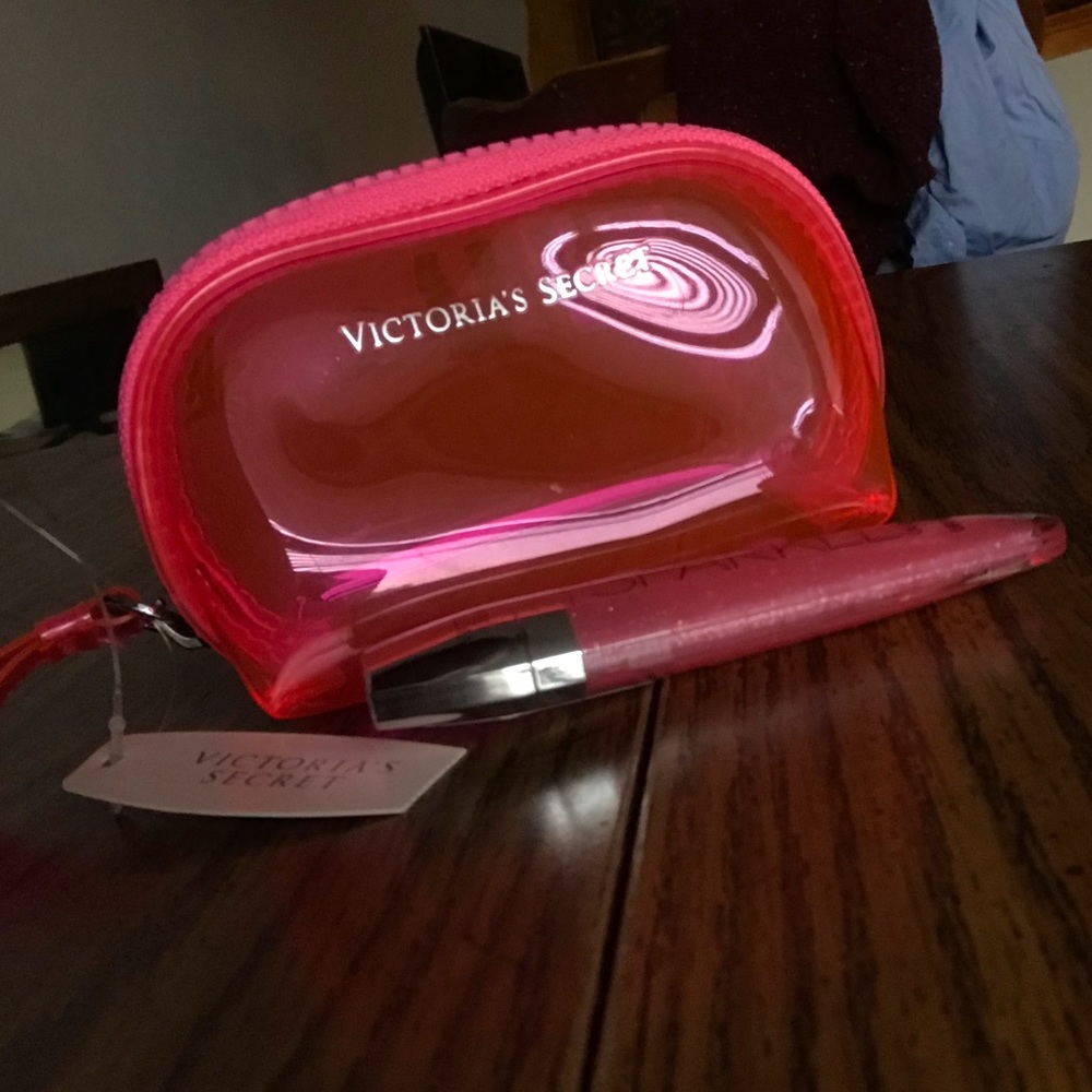 Victoria Secret pink colored pouch and lip gloss